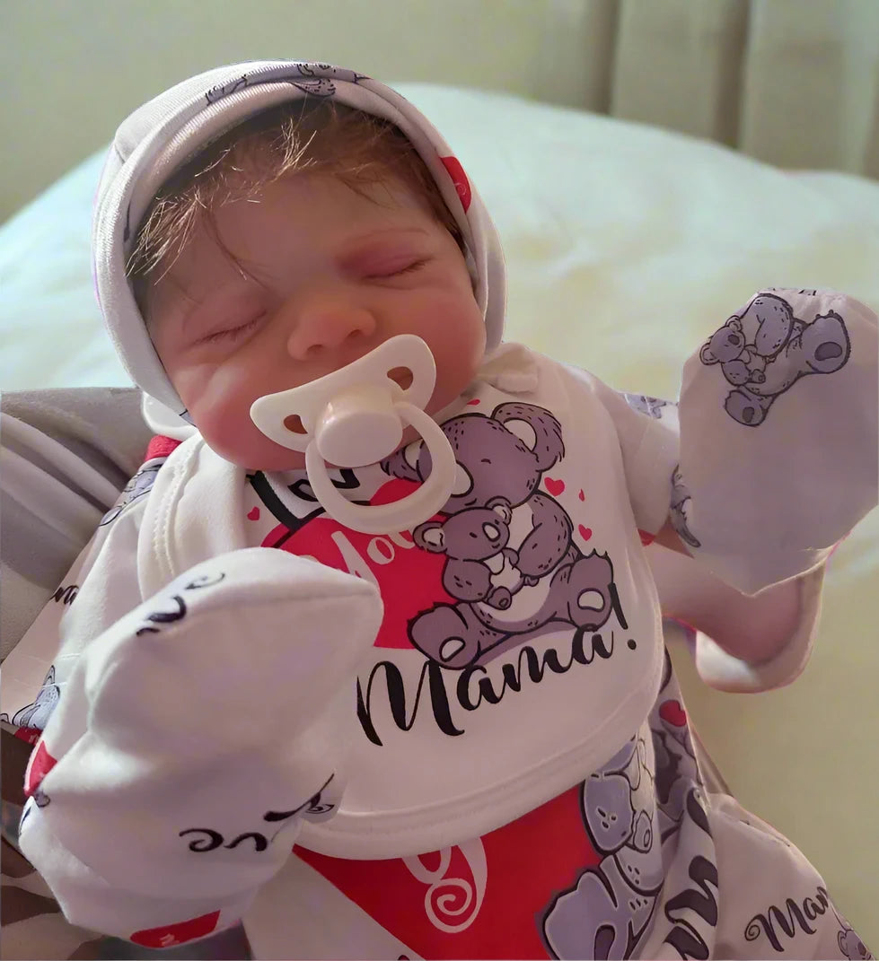 reborn toddler doll sleeping on bed