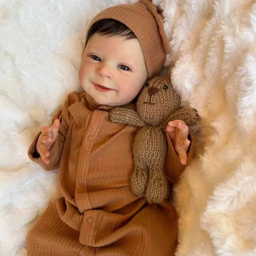newborn baby doll Sebastian in brown dress