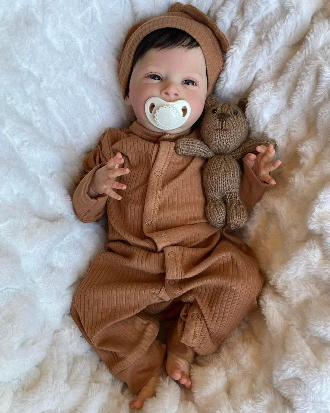 newborn baby doll Sebastian in brown dress