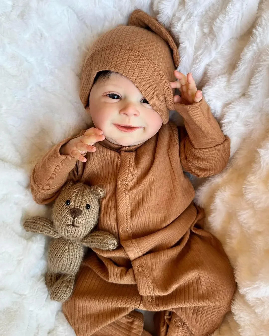 newborn baby doll Sebastian in brown dress