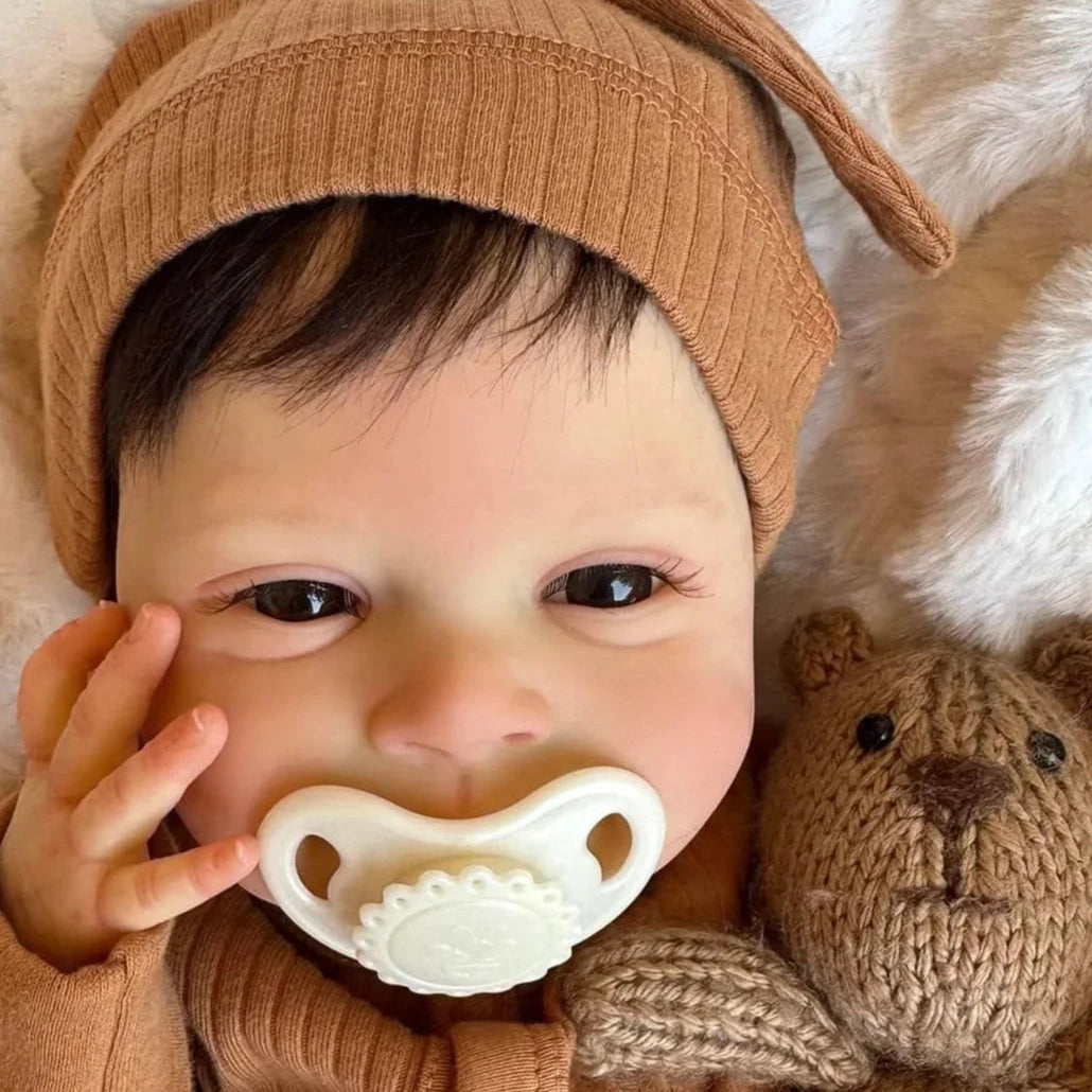 newborn baby doll Sebastian in brown dress