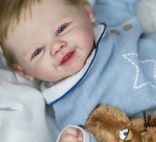 smiling reborn baby doll with blonde hair