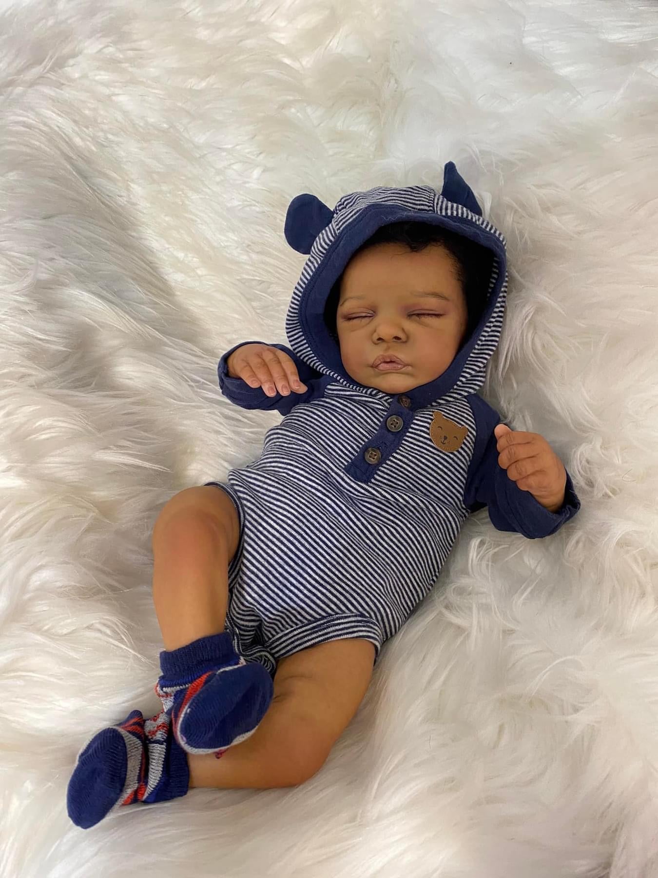 Sleeping reborn baby with black hair