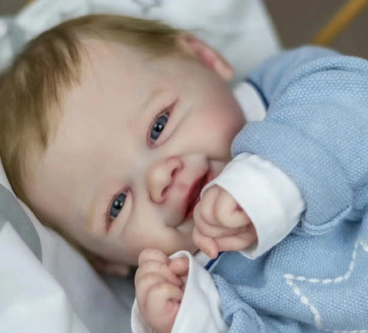 smiling reborn baby doll with blonde hair
